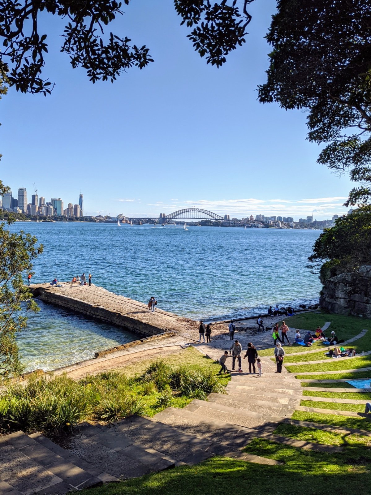 A view across Sydney Harbour from the stone steps beside the water.